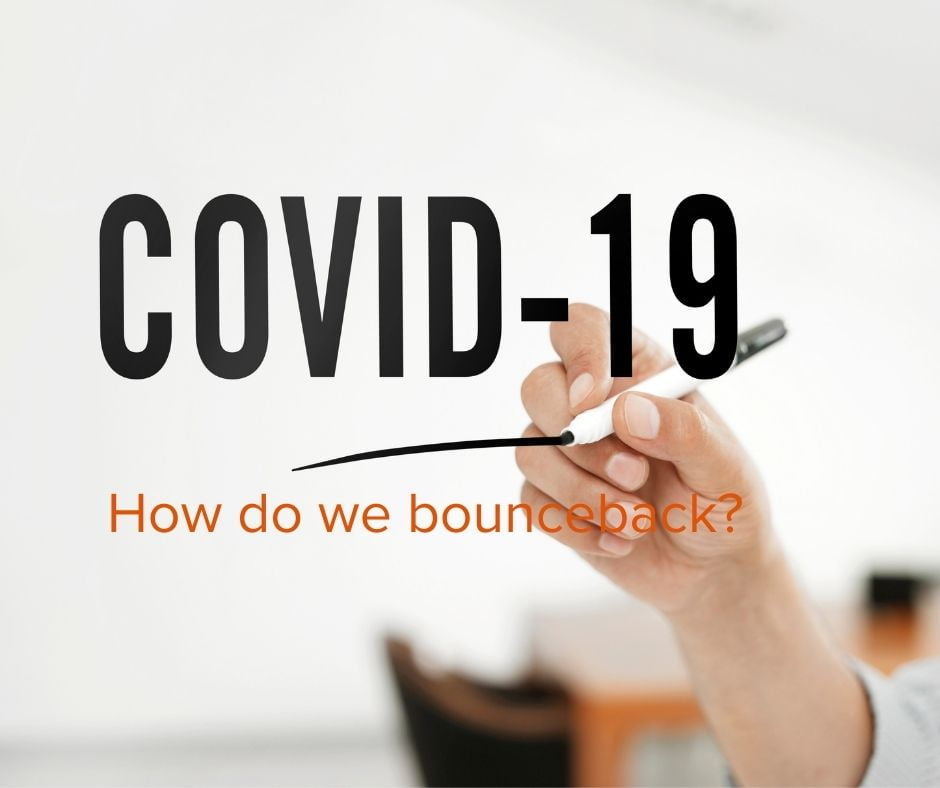 Words "Covid-19 how do we bounce back?" being written on a board