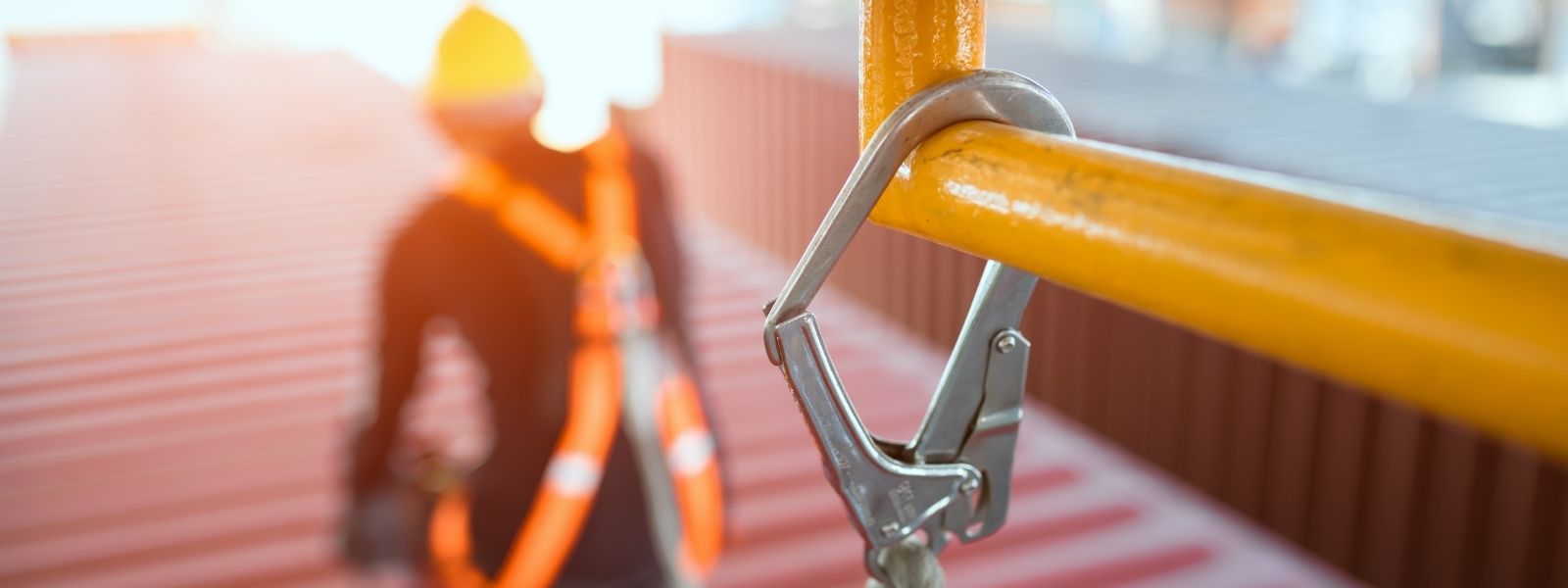 Photograph of close up of caribiner and rope securing a lone working engineer whilst working on a roof.