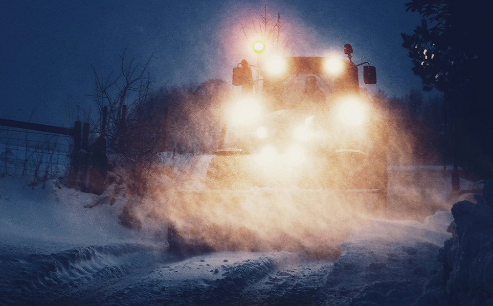 Working in the dark - truck with headlights on being driven at night in the snow. Image courtesy of Dan Cook on unsplash.